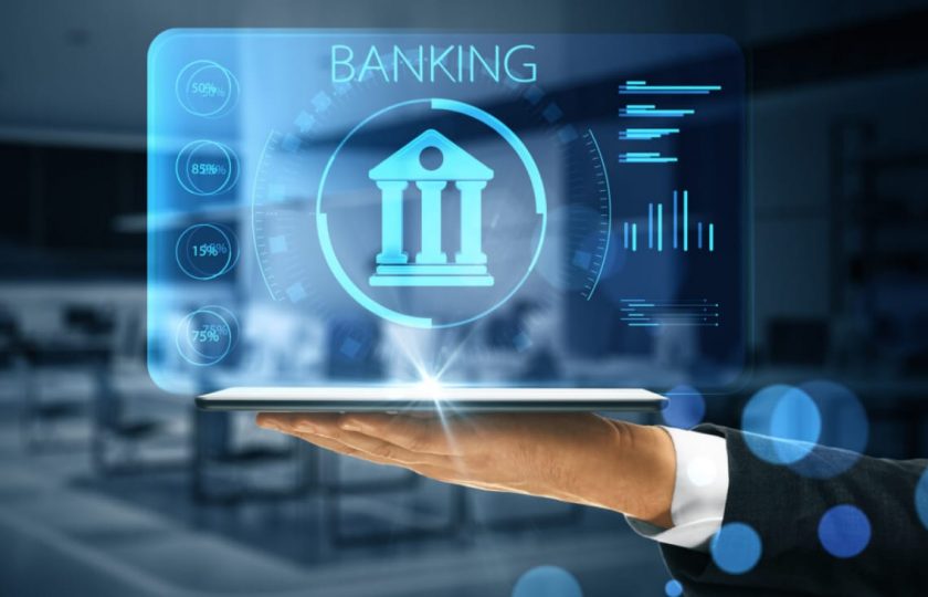 online-banking-application-concept-with-digital-bank-building-sign-with-indicators-virtual-projection-from-digital-tablet-man-hand-e1704684685644-1300×731